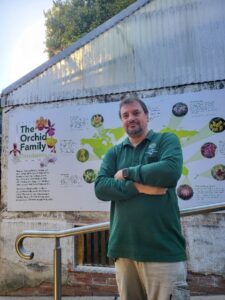 Val Pintilie, Senior Horticulturist in front of the orchid family display house (image supplied by the Royal Botanic Gardens Sydney)