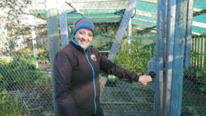 Beverley Sherwood and the Fort Knox-like protective cage in the Plants of Tasmania Nursery retail area (Image: Ploy Rattanakay, Plants of Tasmania Nursery)