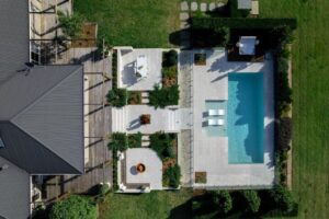 Photographed from above, the new garden connects the home with the pool surround, with a carefully chosen collection of planting, tiles and timber decking