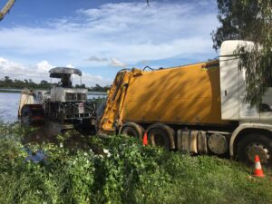 Unloading harvested material into compactor