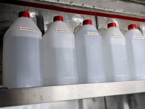 Repurposed ethanol bottles now store distilled water (Image: Lisa Wightwick)