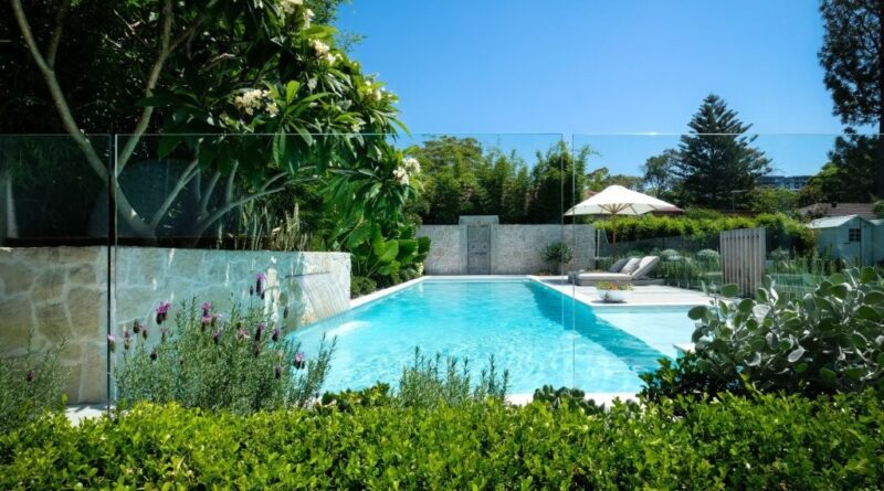 The stunning pool renovation surrounded by hedges, the purple hues of lavender and the successfully transplanted frangipani tree (image supplied by The Landscape Association)