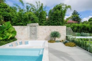 An L-shaped garden inside the pool includes succulents and features Dracaena draco (image supplied by The Landscape Association)
