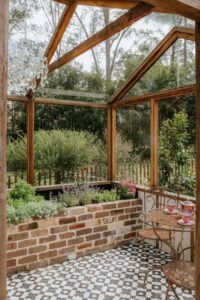 The new glasshouse where three wicking beds are hidden behind a recycled brick wall (Image: Exotic Living)