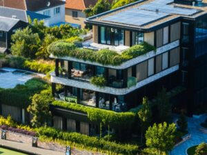 An elegant rooftop garden includes many entertaining spaces, including this gas-powered firepit surrounded by custom-made furniture