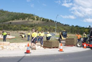 Council staff and apprentices on site installing the new Sir Grange Zoysia turf on the roundabout at Croome Rd, Shellharbour (Image source: Turfco Australia)